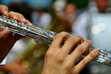 Hands holding a flute.